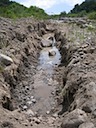 Cutting a footing for river wall stone